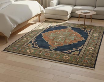 May include: A rectangular area rug with a navy blue field and a central medallion in shades of orange and green. The rug features a detailed floral border in green and beige, adding a touch of elegance to the room.