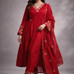 May include: A white ceramic mug with a black handle and the text "But First, Coffee" in a black, bold font. The mug is on a white surface.