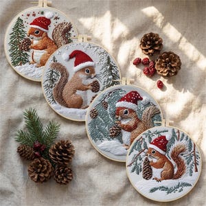 May include: Four circular embroidery hoops featuring detailed needlework of brown squirrels wearing red and white Santa hats. Each squirrel is depicted holding a pinecone amidst embroidered evergreen trees and white snow on a fabric background.