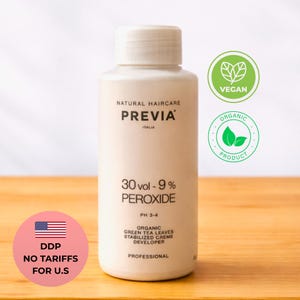 May include: A beige bottle of PREVIA 30 vol - 9% peroxide hair developer. The bottle has a white cap and is labeled "Natural Haircare" and "Organic Product". The image includes a "Vegan" and "Organic Product" seal.
