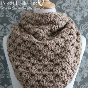 May include: A brown crocheted cowl with a textured stitch pattern. The cowl is displayed on a white mannequin.