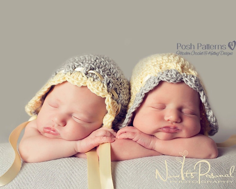 May include: Two newborn babies wearing crocheted hats with yellow and gray trim. The babies are sleeping with their arms crossed in front of them.