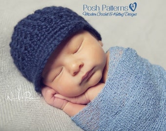 May include: A sleeping baby wearing a blue crocheted hat with a brim. The baby is wrapped in a light blue blanket.