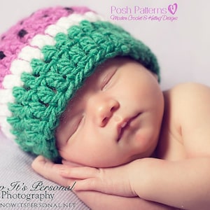 May include: A newborn baby wearing a green, white and pink crocheted watermelon hat. The hat has black seed details. The baby is sleeping with their arms crossed under their chin.