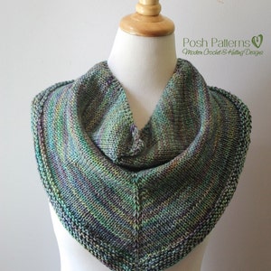 May include: A green, purple, and blue knitted cowl with a textured stitch pattern. The cowl is displayed on a white mannequin.