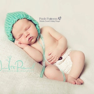 May include: A sleeping baby wearing a light blue crocheted hat and a white crocheted diaper. The baby is lying on a white blanket. The image includes the text "Now It's Personal Photography" and "Posh Patterns Modern Crochet & Knitting Designs".