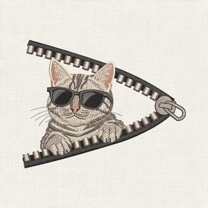 Puede incluir: Un diseño bordado que muestra un gato atigrado de color marrón claro con gafas de sol negras, asomándose detrás de una cremallera negra abierta. El gato tiene bigotes visibles y patas apoyadas en el borde de los dientes de la cremallera.