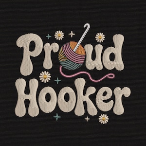 May include: An embroidery design on a black background featuring the text Proud Hooker in a cream-colored, wavy font. A colorful yarn ball with a silver crochet hook is centered, surrounded by small white daisy flowers and tiny teal plus signs.