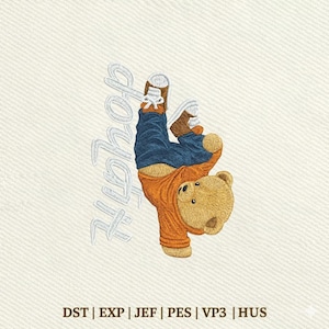 May include: An embroidery design featuring a tan teddy bear performing a handstand while wearing a bright orange long-sleeve shirt and dark blue jeans with white trainers. The word "HipHop" is embroidered in white script to the left of the bear.