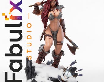 May include: A detailed figurine of a warrior woman with red hair, clad in armor and holding a sword and axe. The figure stands on a snowy base with a shield and arrows. The Fabulix Studio logo is visible.