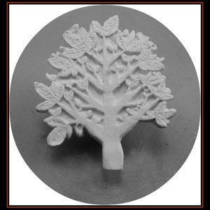 May include: A white ceramic tree sculpture with a detailed design of leaves and branches. The tree is mounted on a round, white base.