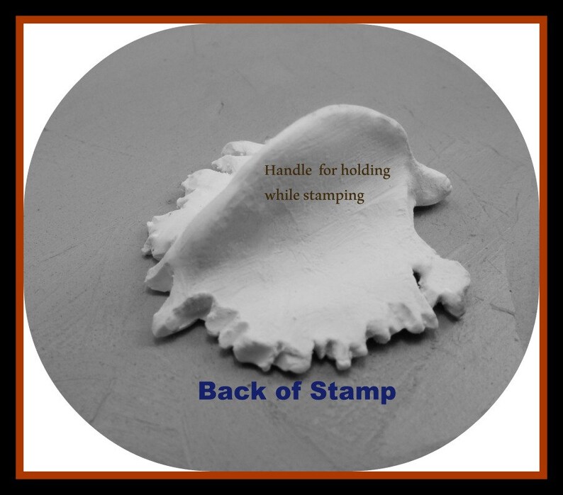 May include: A close-up of the back of a white clay stamp with a handle for holding while stamping. The text "Back of Stamp" is printed below the stamp.