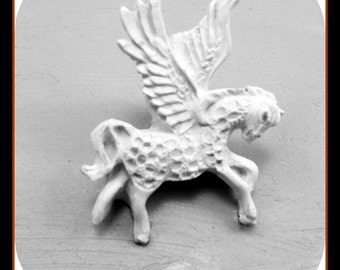May include: A white ceramic figurine of a winged horse, or pegasus, with detailed wings and a textured body.