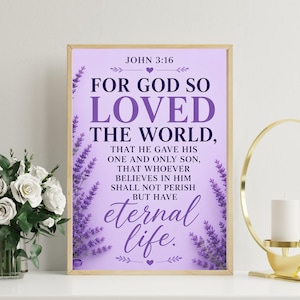 May include: A rectangular wall art print with a light purple background featuring the Bible verse John 3:16 in dark purple text. The design is framed by vertical sprigs of lavender flowers on the left and right sides with small heart icons.