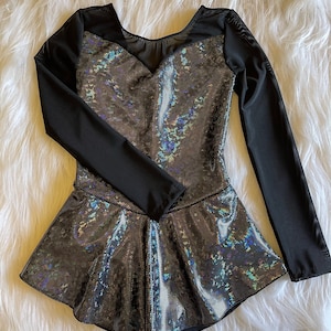 May include: A black and iridescent long-sleeved leotard with a mesh neckline and a flared skirt.