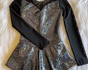 May include: A black and iridescent long-sleeved leotard with a mesh neckline and a flared skirt.