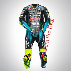 May include: A black, teal, and neon yellow leather motorcycle racing suit featuring multiple sponsor logos including Petronas, Yamaha, Sprinta, and VR46. The suit has a front zipper closure, protective knee sliders, and various brand patches.