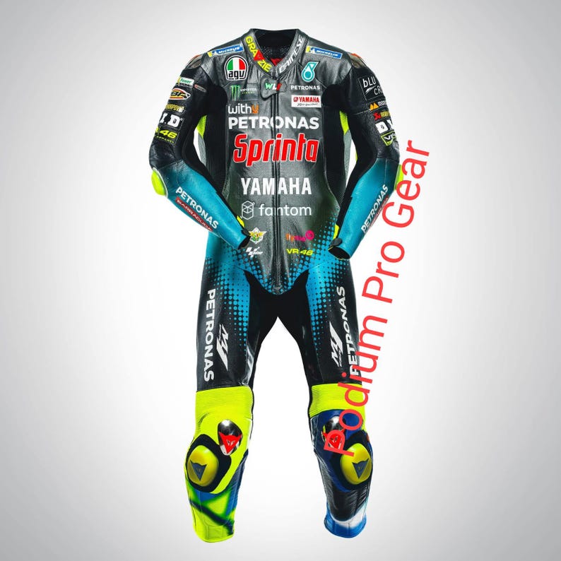 May include: A black, teal, and neon yellow leather motorcycle racing suit featuring multiple sponsor logos including Petronas, Yamaha, Sprinta, and VR46. The suit has a front zipper closure, protective knee sliders, and various brand patches.