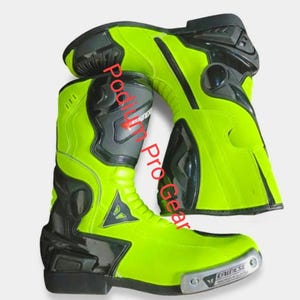 May include: A pair of neon yellow and black motorcycle boots featuring the Dainese logo on the side and a metallic toe slider with the text Podium Pro Gear overlaid on the image. The boots have a high-cut design with reinforced black panels.