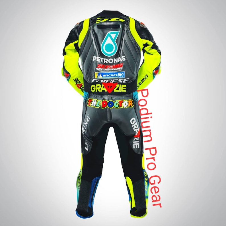 May include: A black, grey, and neon yellow motorcycle racing suit featuring the Petronas logo, Michelin branding, and the text "GRAZIE" and "THE DOCTOR" on the back. The suit includes Dainese branding and various racing sponsor logos.