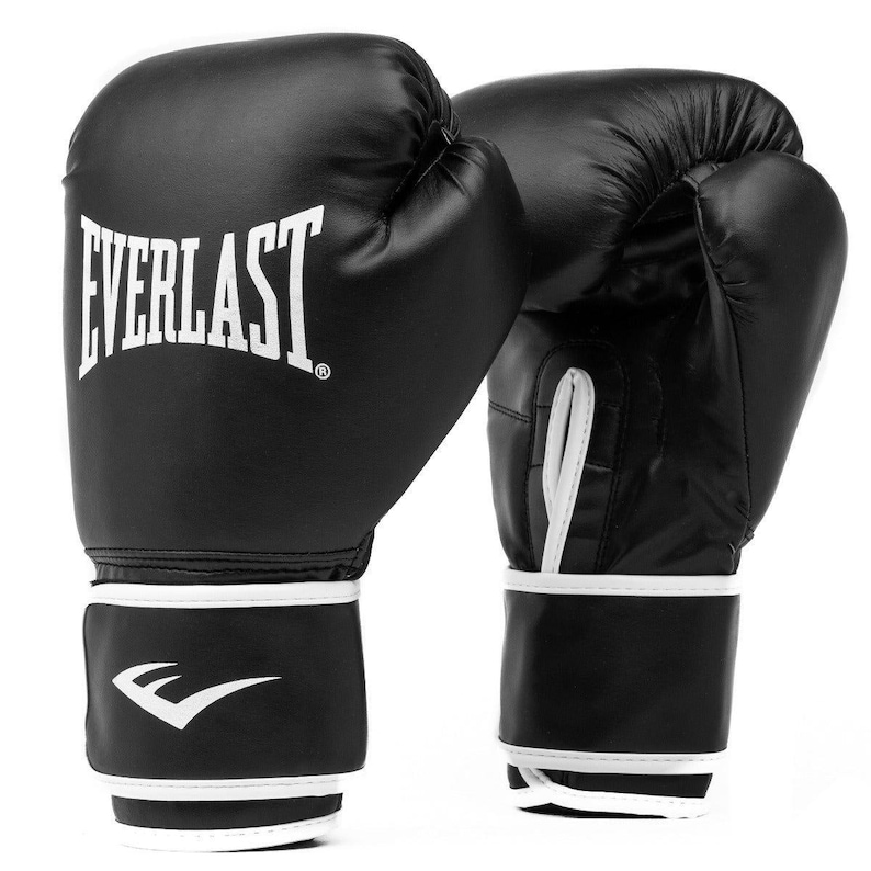 May include: A pair of black Everlast boxing gloves. The gloves feature white trim and the Everlast logo in white. These gloves are designed for boxing and other combat sports, made from a durable material.