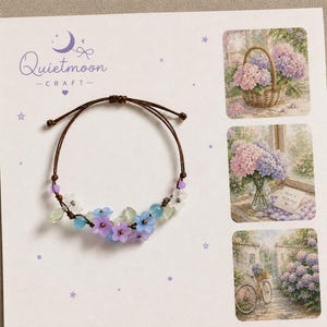 May include: A brown cord bracelet featuring small translucent blue and purple flower-shaped beads, clear leaf-shaped beads, and small round beads. The bracelet is displayed on a white card with the text Quietmoon CRAFT and three floral images.