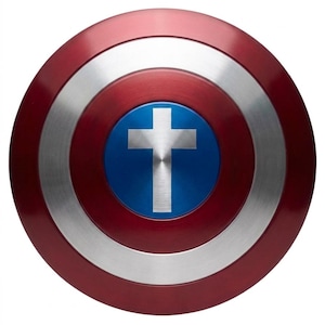 May include: A circular shield featuring concentric rings of metallic red and silver. The center consists of a solid blue circle with a silver cross emblem positioned in the middle. The surface has a brushed metal texture throughout the design.