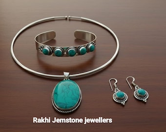 May include: A jewelry set featuring a silver necklace, bracelet, pendant, and earrings. The set includes turquoise-colored gemstones. The text "Rakhi Jemstone jewellers" is at the bottom of the image.