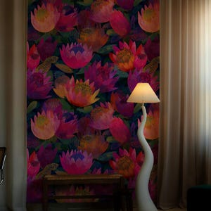 May include: A colourful floral wallpaper with large, stylised flowers in pink, orange, and purple against a dark background. A white, curved floor lamp with a pleated lampshade stands to the right. A small wooden bench is in front of the wallpaper.