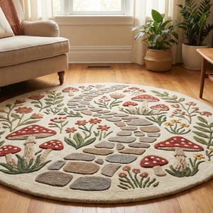 May include: A circular rug with a cream background, decorated with a fantasy design. The rug depicts a stone path surrounded by red-capped mushrooms, flowers, and green leaves. The rug is placed on a wooden floor.