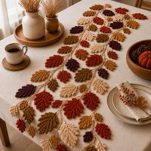 May include: A crochet table runner featuring a vine-like structure with numerous oak leaves in shades of cream, mustard yellow, burnt orange, and deep burgundy. The runner is laid out on a light-colored tablecloth, accompanied by ceramic vases.