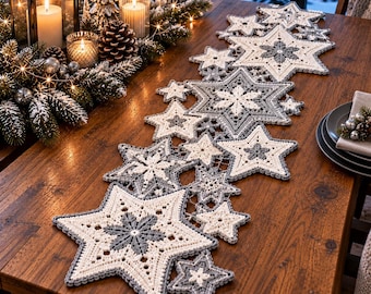 May include: A crochet table runner featuring a series of interconnected star and snowflake motifs in cream and grey yarn. The runner is composed of various sizes of stars arranged in a linear pattern, showcasing intricate stitching and geometric shapes.