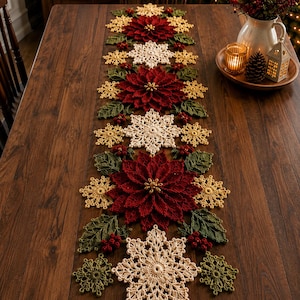 May include: A long, rectangular crochet table runner featuring a repeating pattern of deep red poinsettia flowers, cream-colored snowflakes, golden-yellow star-shaped motifs, dark green leaves, and small clusters of red berries arranged in a line.