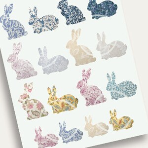 May include: A sheet of paper with 15 bunny silhouettes, each filled with a different floral pattern. The bunnies are arranged in a grid pattern, with three rows of five bunnies each. The patterns are in shades of blue, pink, yellow, and white.