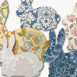 May include: Five fabric bunny shapes in various floral and paisley patterns. The bunnies are in shades of blue, yellow, pink, and white.