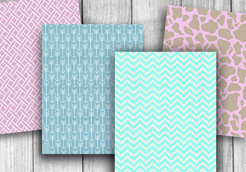 May include: Four different patterned paper sheets. The first sheet is pink with a white criss-cross pattern. The second sheet is blue with a white arrow pattern. The third sheet is light blue with a white chevron pattern. The fourth sheet is pink with a brown cow print pattern.