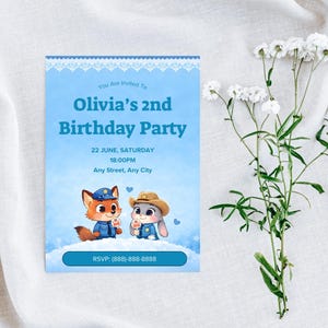 May include: A light blue birthday party invitation with the text "Olivia's 2nd Birthday Party". The invitation features cartoon characters and the RSVP phone number. White flowers are in the background.