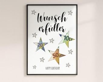 May include: A framed print with the words "Wunsch Erfüller" in black script, featuring star-shaped cutouts of Euro banknotes. The print includes the text "HAPPY BIRTHDAY" and several small star illustrations.