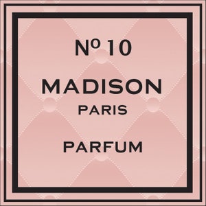 May include: A pink and black perfume bottle label with the text "No. 10 MADISON PARIS PARFUM".