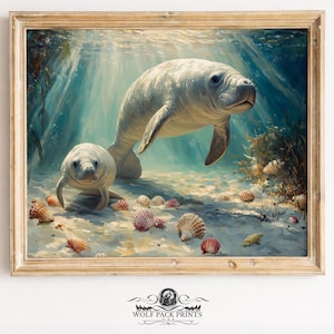 May include: An artistic print of two manatees swimming underwater, surrounded by seashells and aquatic plants. The artwork is framed in a light-colored wooden frame, with the Wolf Pack Prints logo at the bottom.