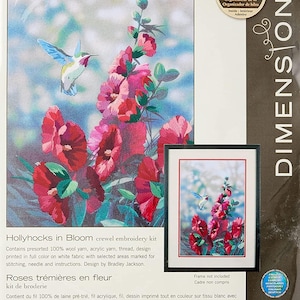May include: Crewel embroidery kit with a floral design of red hollyhocks and a hummingbird. The kit includes pre-sorted wool and acrylic yarn, thread, and instructions. The design measures 27.9 cm by 40.6 cm.