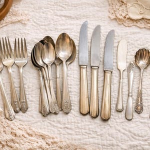 May include: A set of three ceramic mugs with a speckled, matte finish. The mugs are in shades of cream, light gray, and dark gray. Each mug has a simple, minimalist design and a rounded handle.