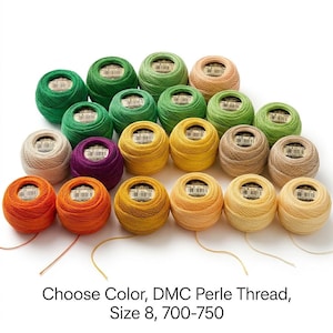 May include: A collection of DMC Perle thread balls in size 8, featuring a variety of colors including shades of green, yellow, orange, purple, and beige. Each ball has a white label with black text and a barcode. Text reads: Choose Color, DMC Perle Thread, Size 8, 700-750.