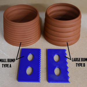May include: Two terracotta-colored, cylindrical pots with horizontal ridges, paired with two blue plastic tools. The tools have a rectangular shape with two circular holes and a serrated edge. Text labels identify the tools.
