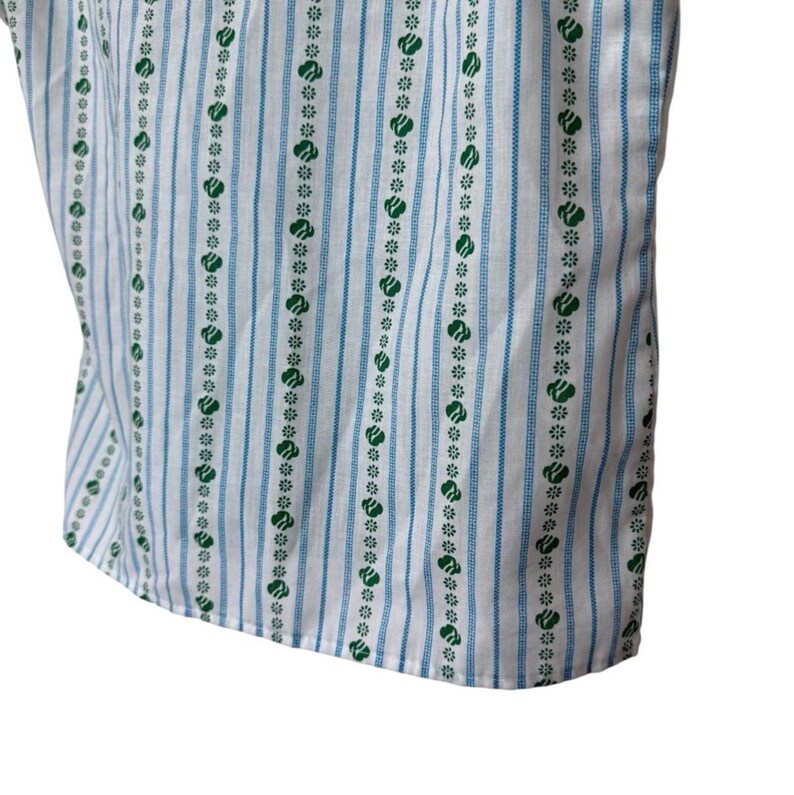 May include: Close-up of a white fabric with vertical blue stripes and rows of green floral patterns. The fabric curves slightly, indicating it's part of a garment. The design is clean and simple, with a fresh, summery feel.
