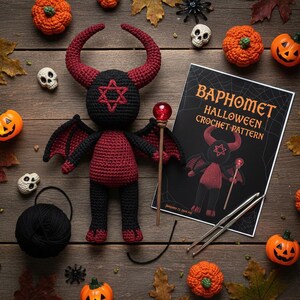 May include: A handmade crochet Baphomet doll with red and black details, including horns, wings, and a star symbol. The doll is surrounded by Halloween-themed decorations, including pumpkins, skulls, and a crochet pattern titled "Baphomet Halloween Crochet Pattern."