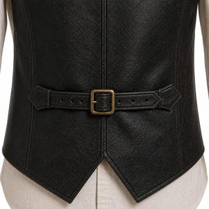 Close up of adjustable back strap on leather vest, antique brass buckle vintage black distressed leather detail