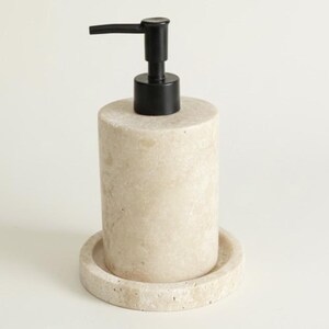 May include: A beige stone soap dispenser with a black pump and a circular base. The cylindrical dispenser is designed for liquid soap and is suitable for a bathroom or kitchen setting.