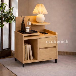 May include: A rustic wooden sign with the text "Welcome to our home" in white lettering. The sign has a distressed finish and a simple, inviting design, ideal for front door decor.