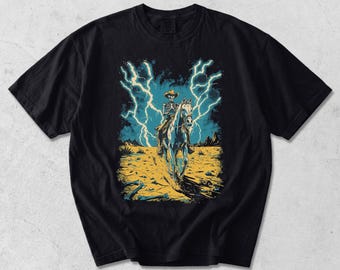 Camiseta de vaquero esqueleto, camiseta gráfica western vintage, camiseta de jinete de calavera del desierto con relámpagos, estética vaquera gótica